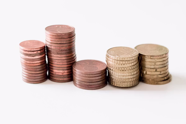 Gold coins stacked on dark surface